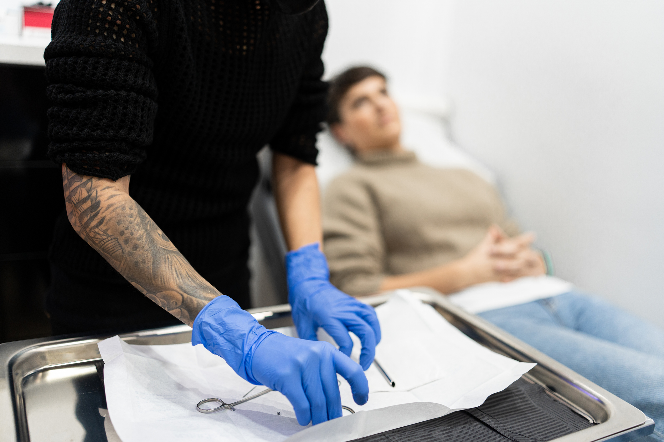 glove,adult,female,person,woman,pen,face,head,tattoo,writing