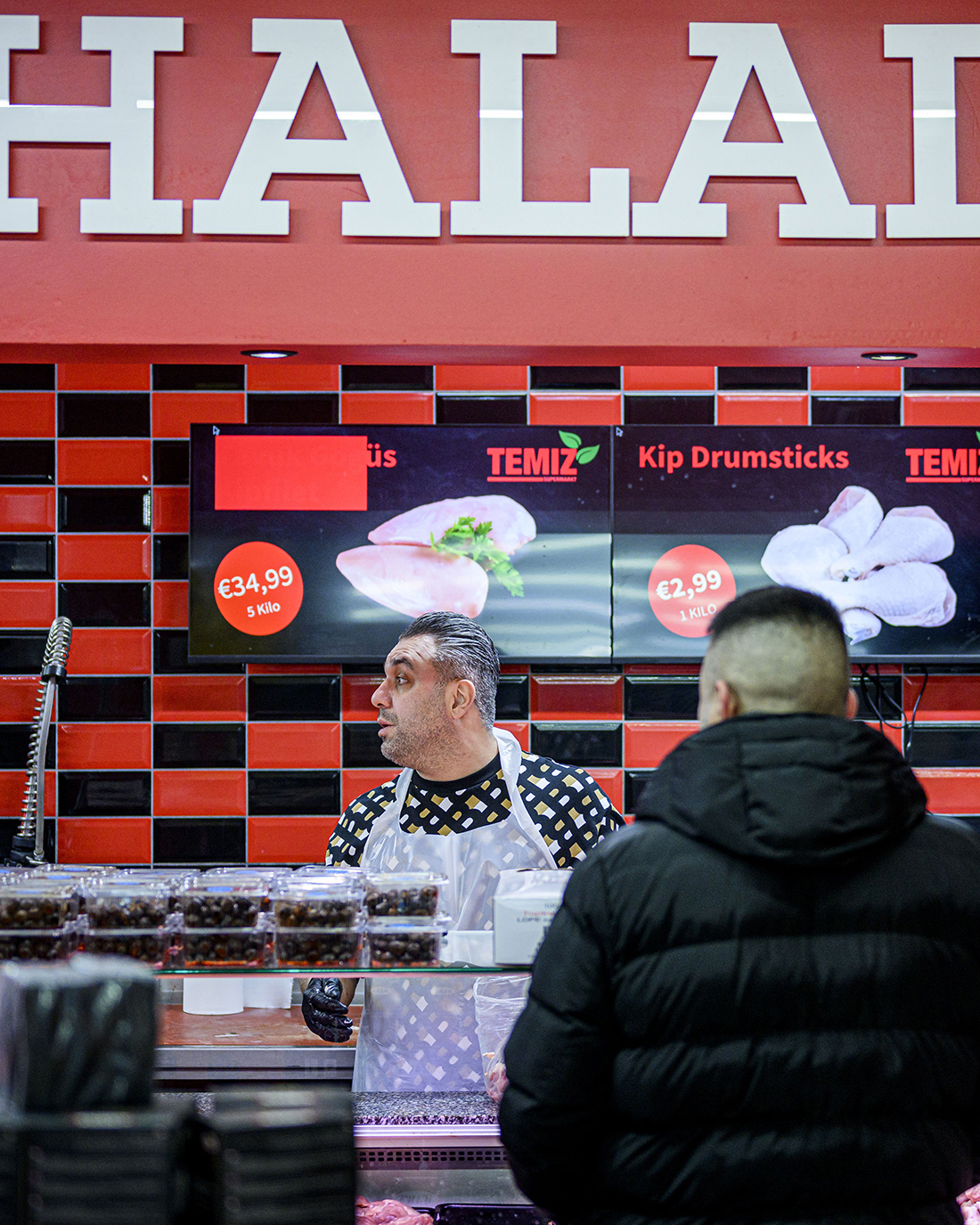 indoors,restaurant,adult,male,man,person,cafeteria,food court,coat,face