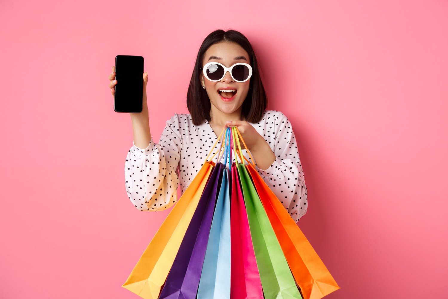 attractive-asian-woman-showing-smartphone-app-shopping-bags-buying-online-via-application-standi.jpg