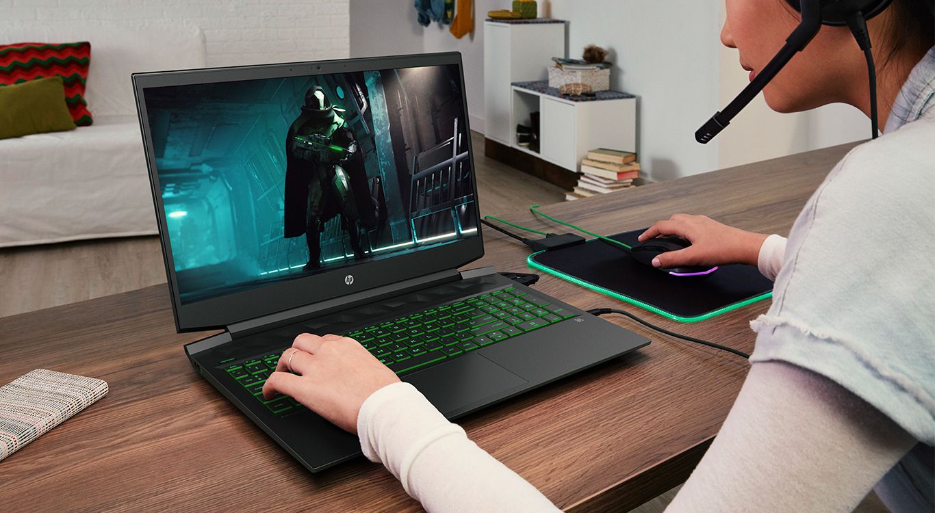 laptop,computer keyboard,monitor,adult,male,man,person,video gaming,female,woman