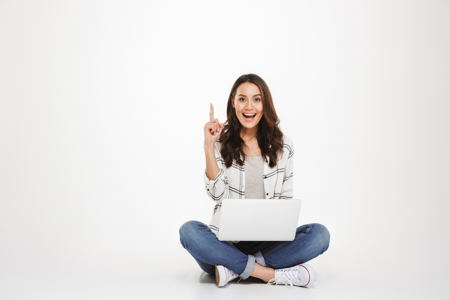 happy-brunette-woman-shirt-sitting-floor-with-laptop-computer-while-having-idea-looking-camera-gray.jpg