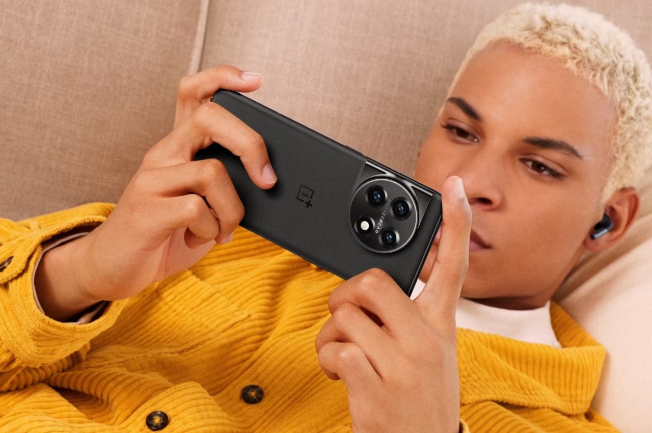 photography,mobile phone,adult,female,person,woman,head,face,baby,earbuds