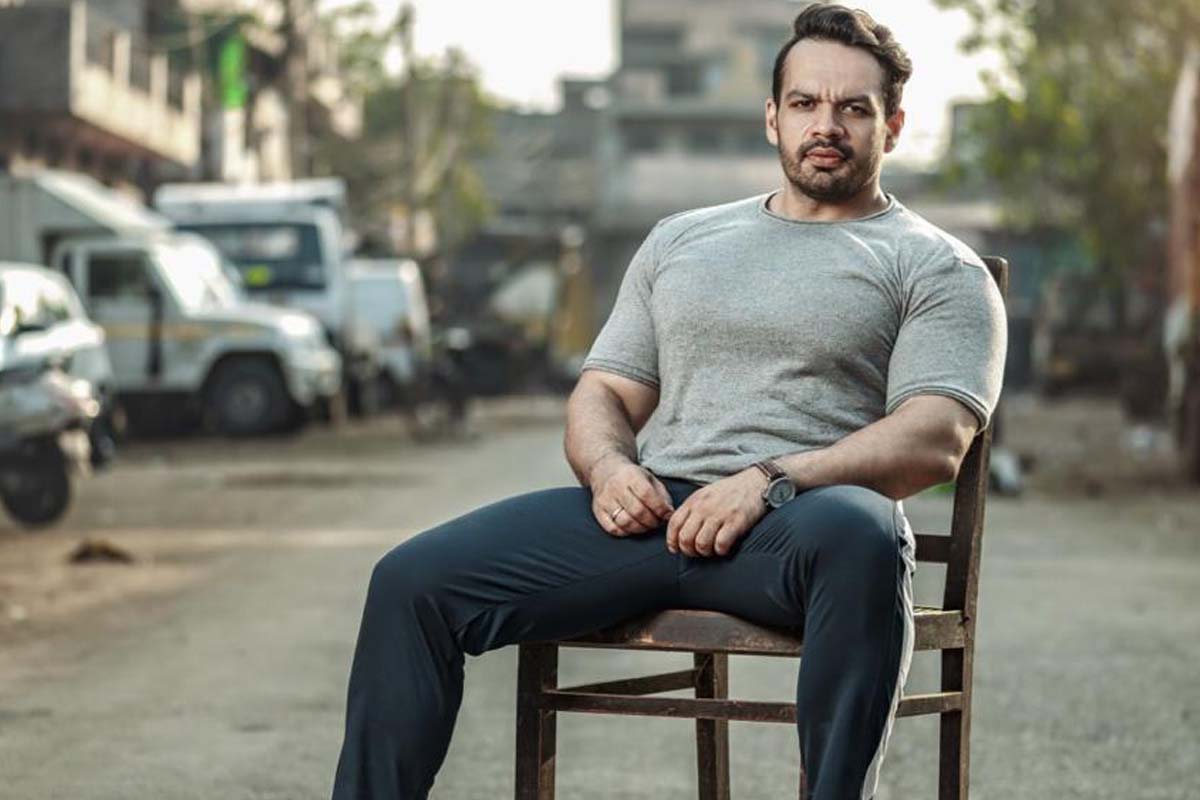 person,sitting,adult,male,man,pants,wheel,jeans,sleeve,face