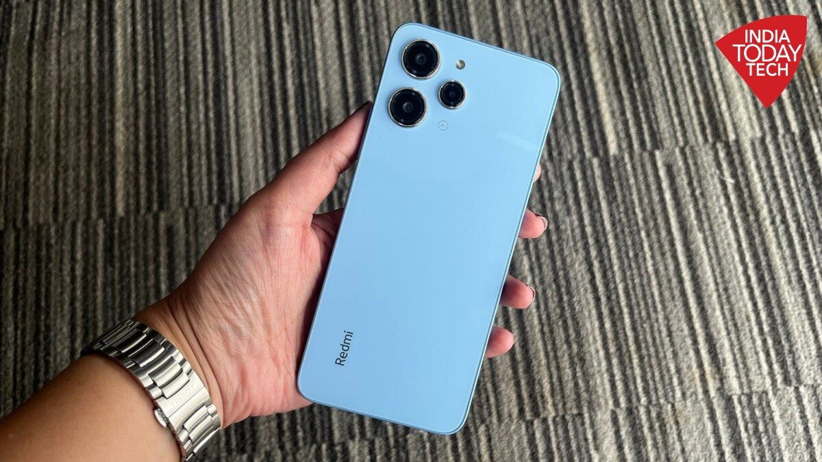 electronics,mobile phone,phone,iphone,wristwatch,person