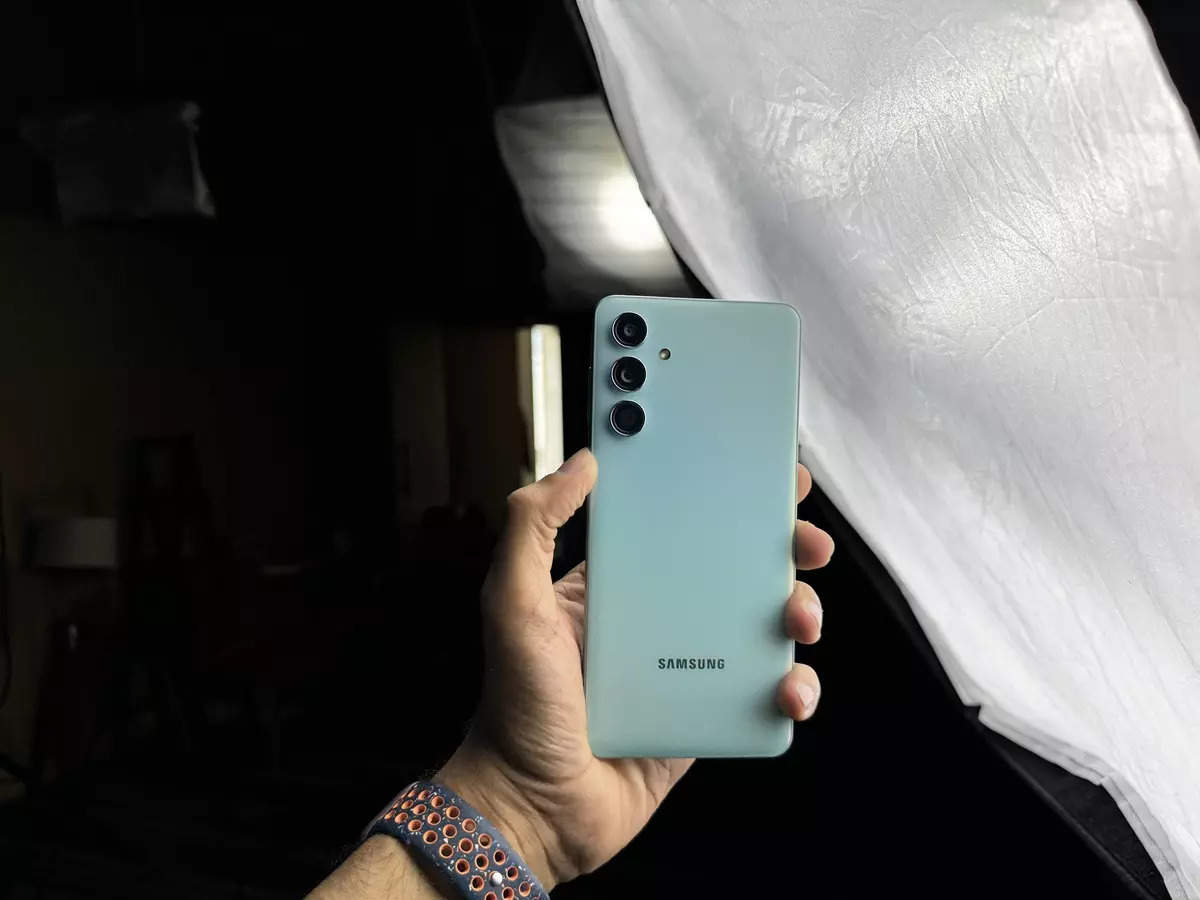 electronics,mobile phone,phone,remote control,face,head,person,selfie