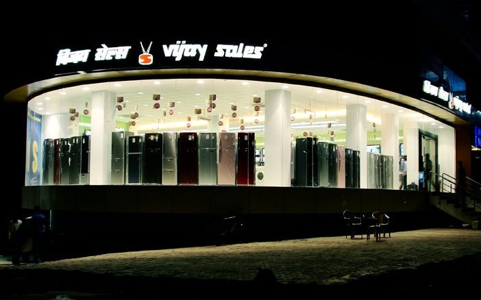 shopping mall,shop,lighting,person,furniture,monitor,outdoors,chair,indoors,refrigerator