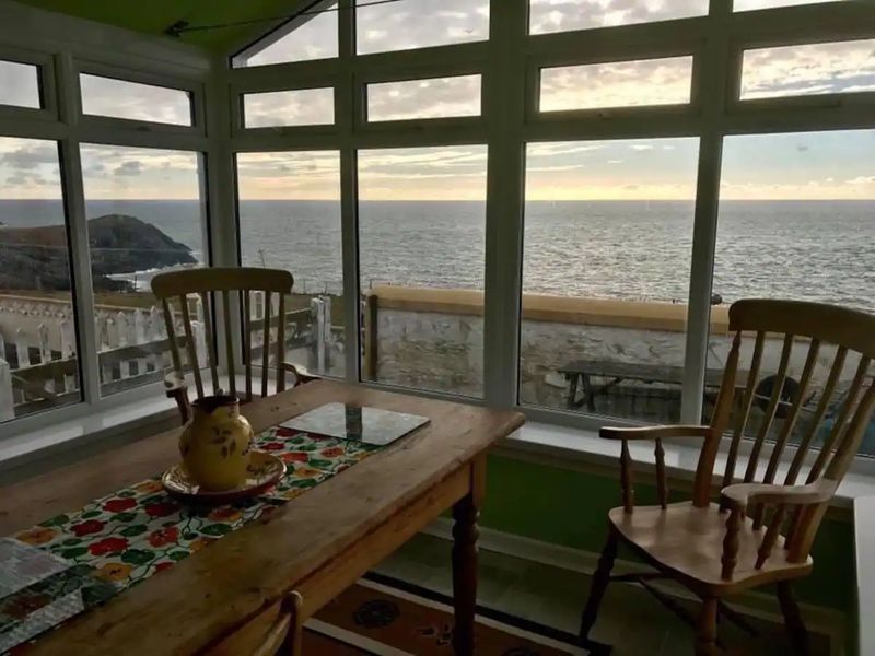 window,indoors,sunset,water,table,chair