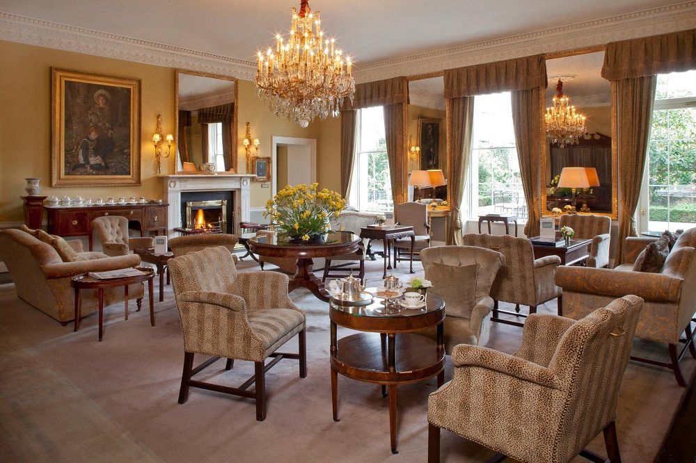 indoors,tables,chairs,lamp,curtsains,diningroom,tea,cups,biscuits,flowers
