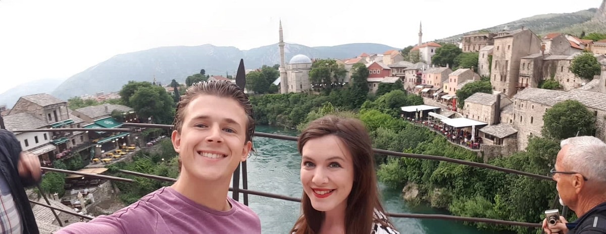 selfie,couple,male,female,water,moutain,buildings