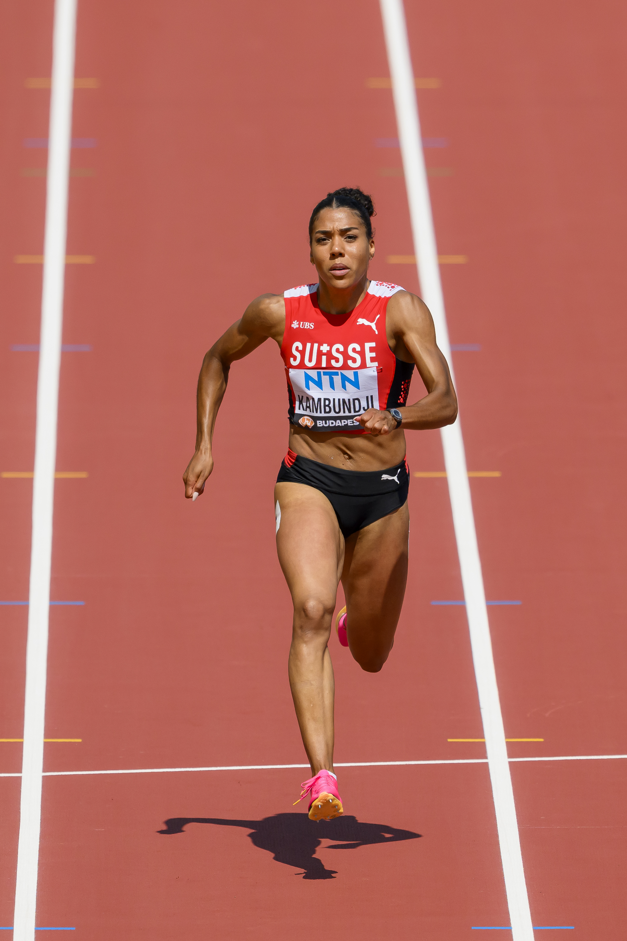 adult,male,man,person,athlete,sport,wristwatch,shoe,running track,shorts