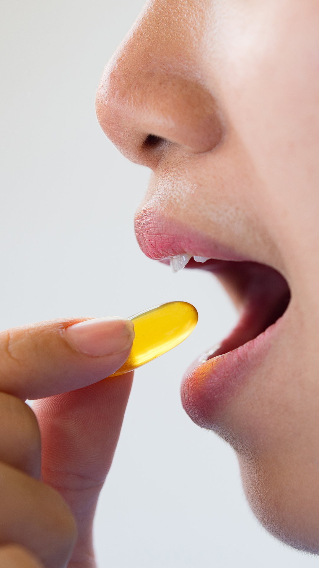face,head,person,medication,adult,female,woman,pill,finger,hand