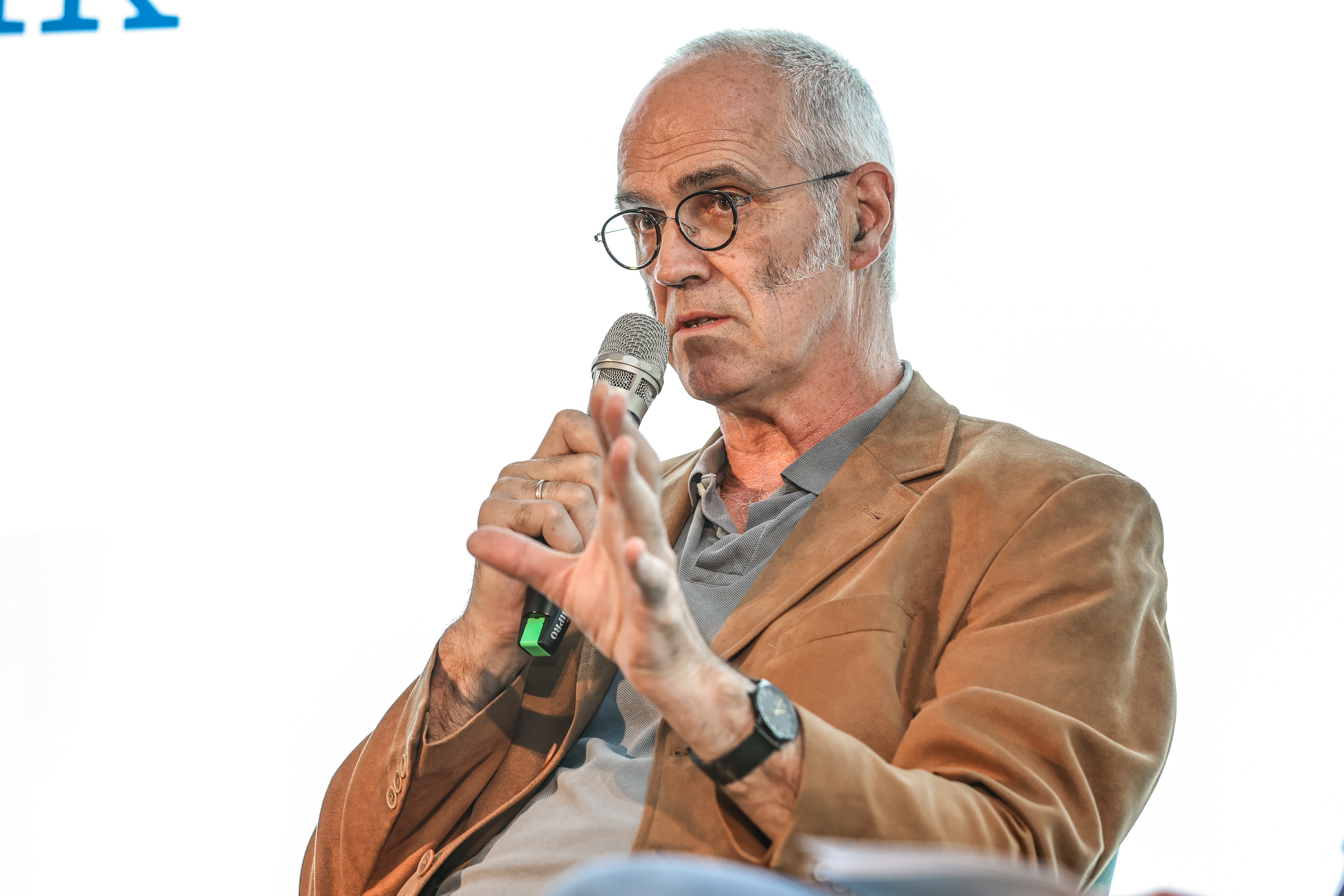 microphone,people,person,crowd,wristwatch,adult,male,man,glasses,audience