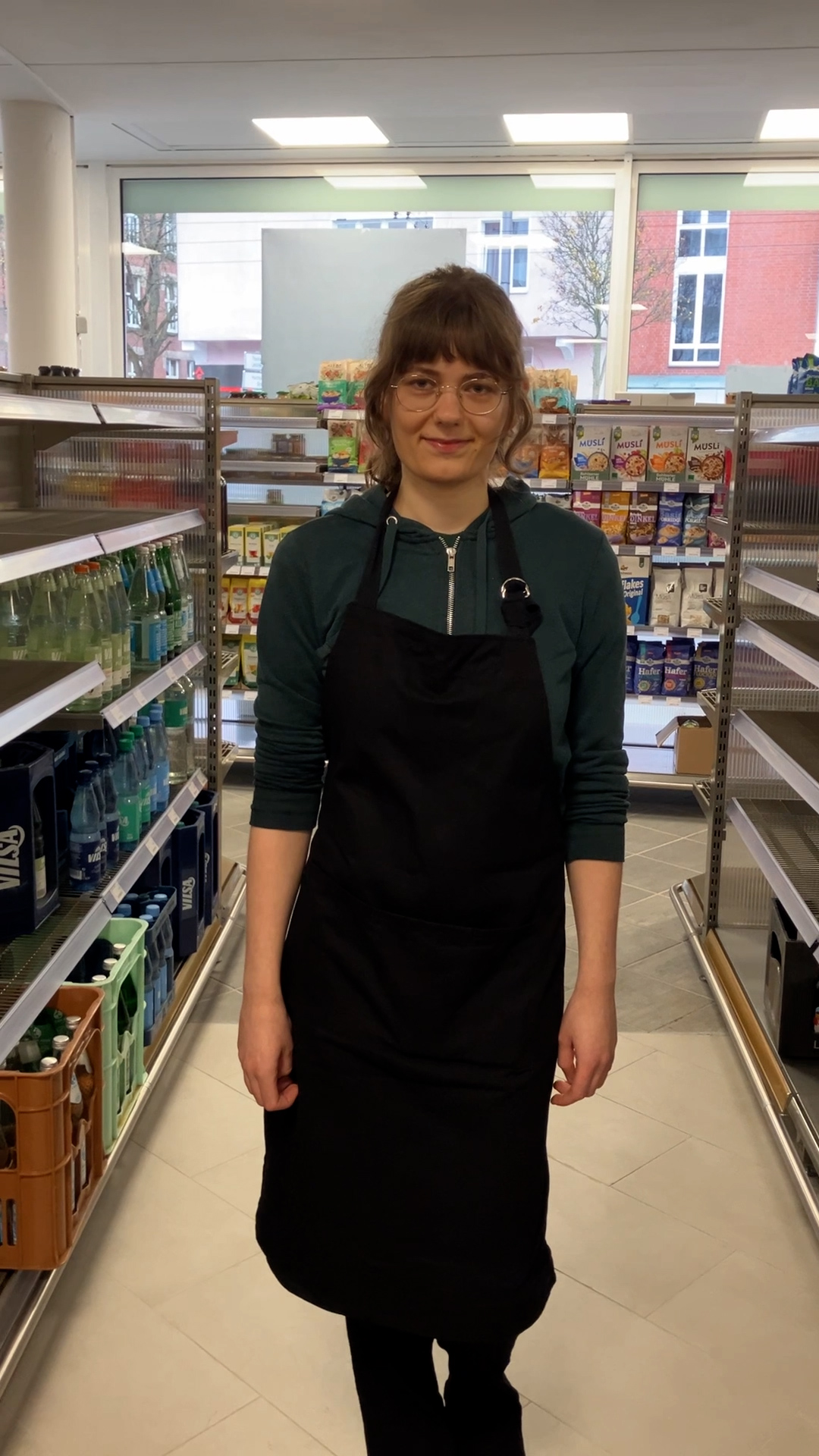 shelf,adult,female,person,woman,shop,face,head,standing,glasses