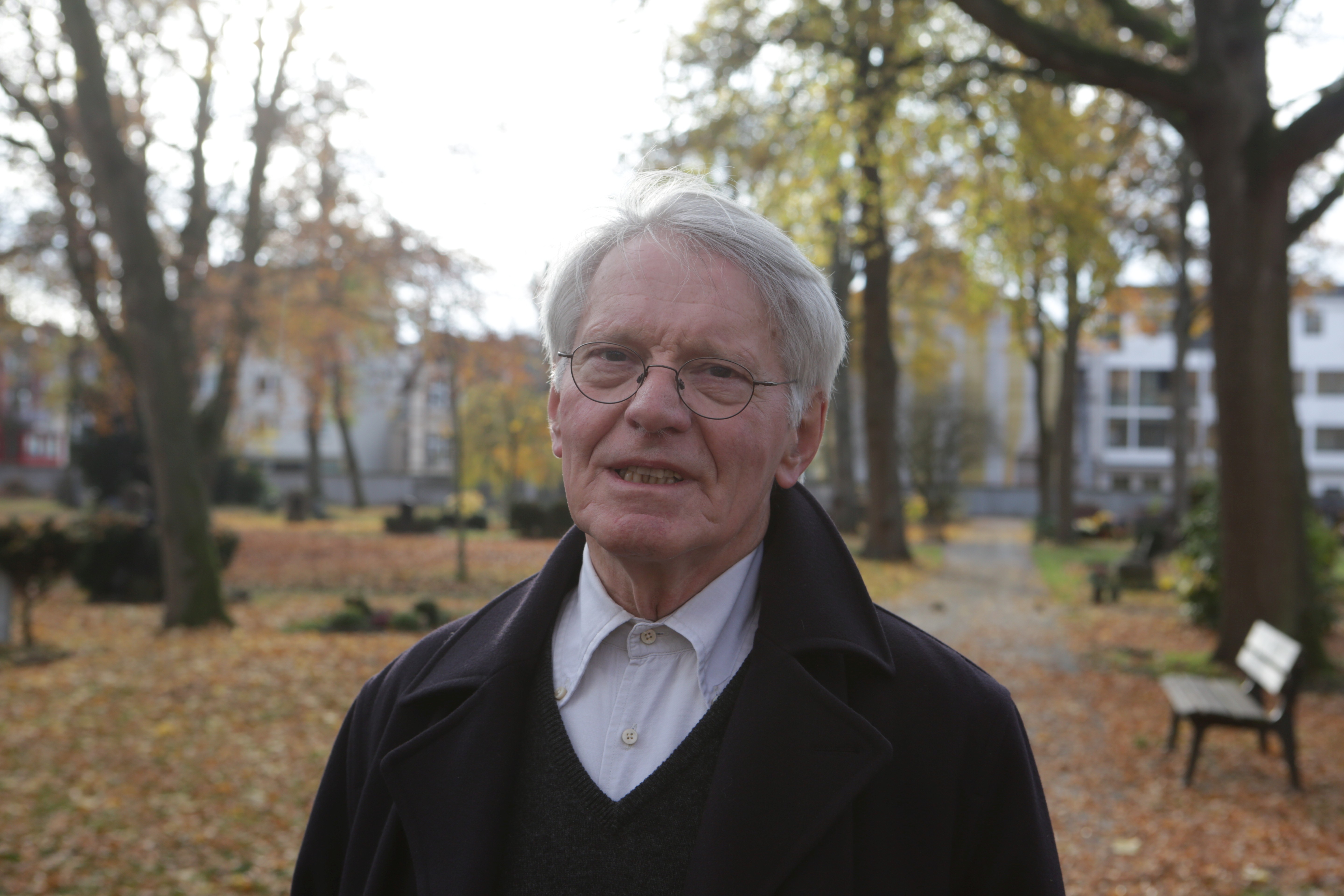bench,coat,adult,male,man,person,photography,portrait,tree,tree trunk