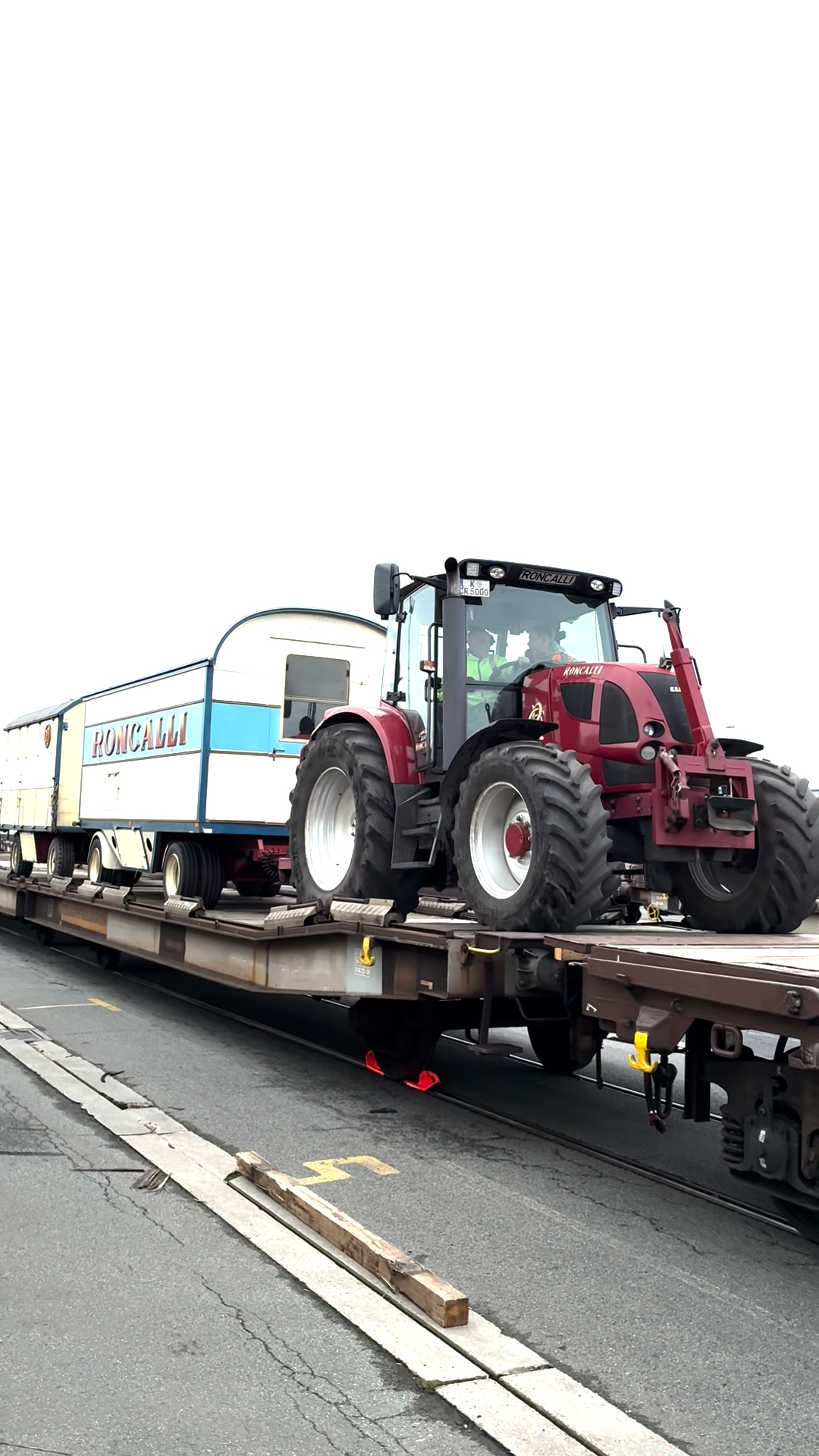 bulldozer,machine,wheel,person,vehicle,railway,tractor,tire,truck,train